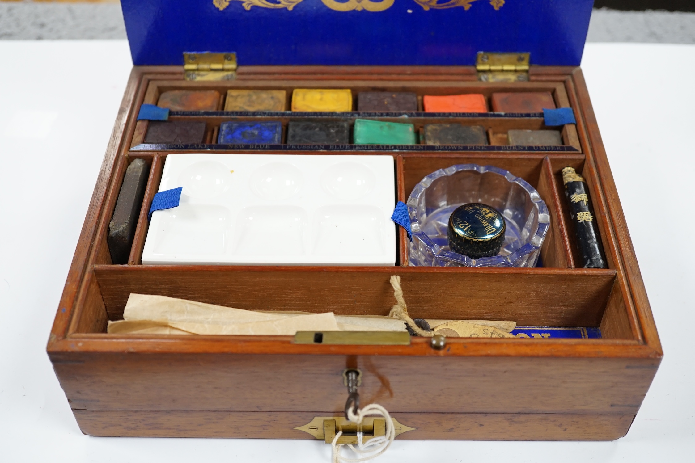 A Victorian Winsor and Newton artist's box with watercolour blocks, palettes etc. with key. Condition - fair
